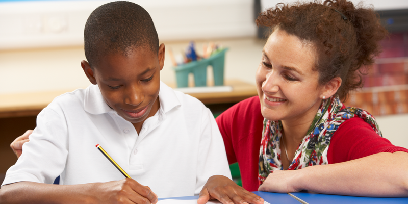 young-boy-student-receiving-expert-tuition-from-tutor-in-person