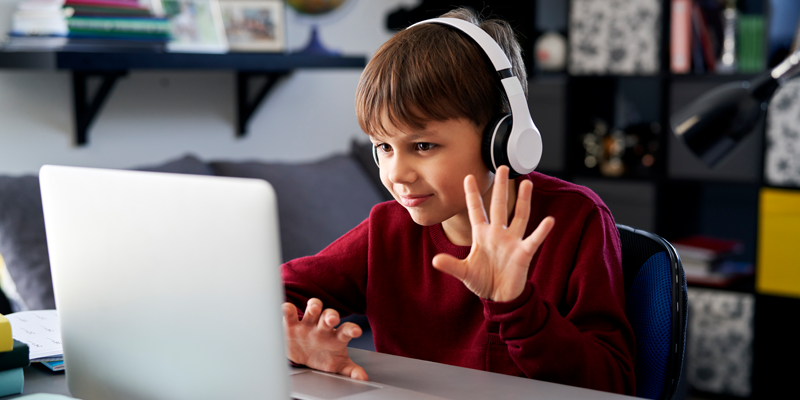 child-student-using-laptop-to-speak-with-tutor-through-home-tuition